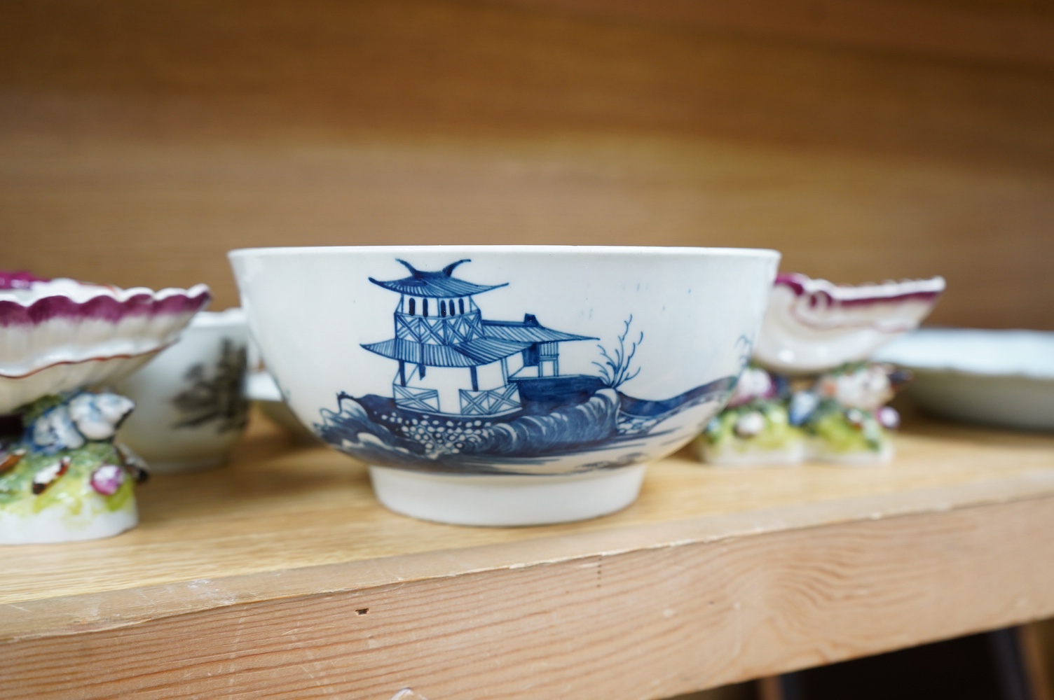 A Worcester coffee cup and saucer, Milkmaid pattern by Hancock, a pair of English porcelain shell salts, and a Worcester blue and white bowl, 18cm (5). Condition - fair